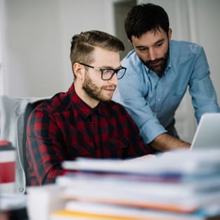 two people working on a computer